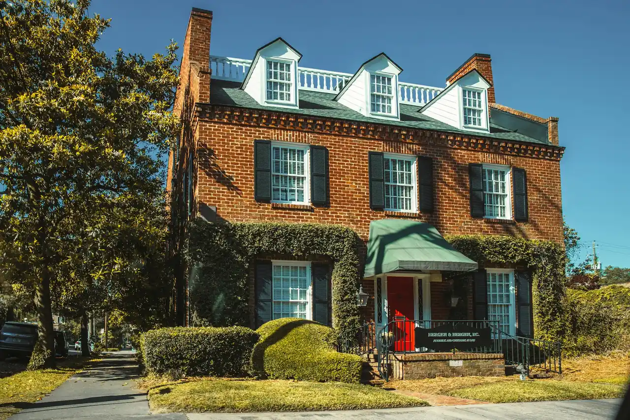 Brick colonial home with dormers and a shingle roof