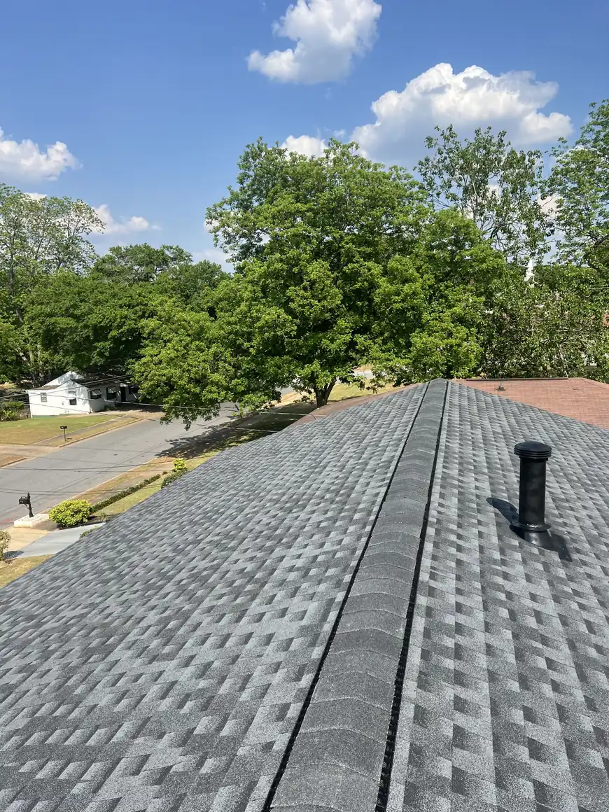 Completed gray architectural shingle roof with ridge vent