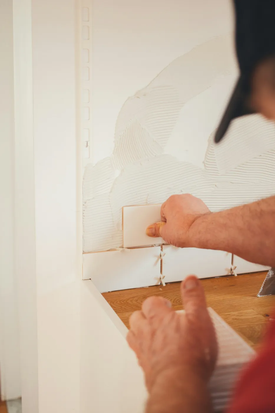 Drywall patch being smoothed on an interior wall