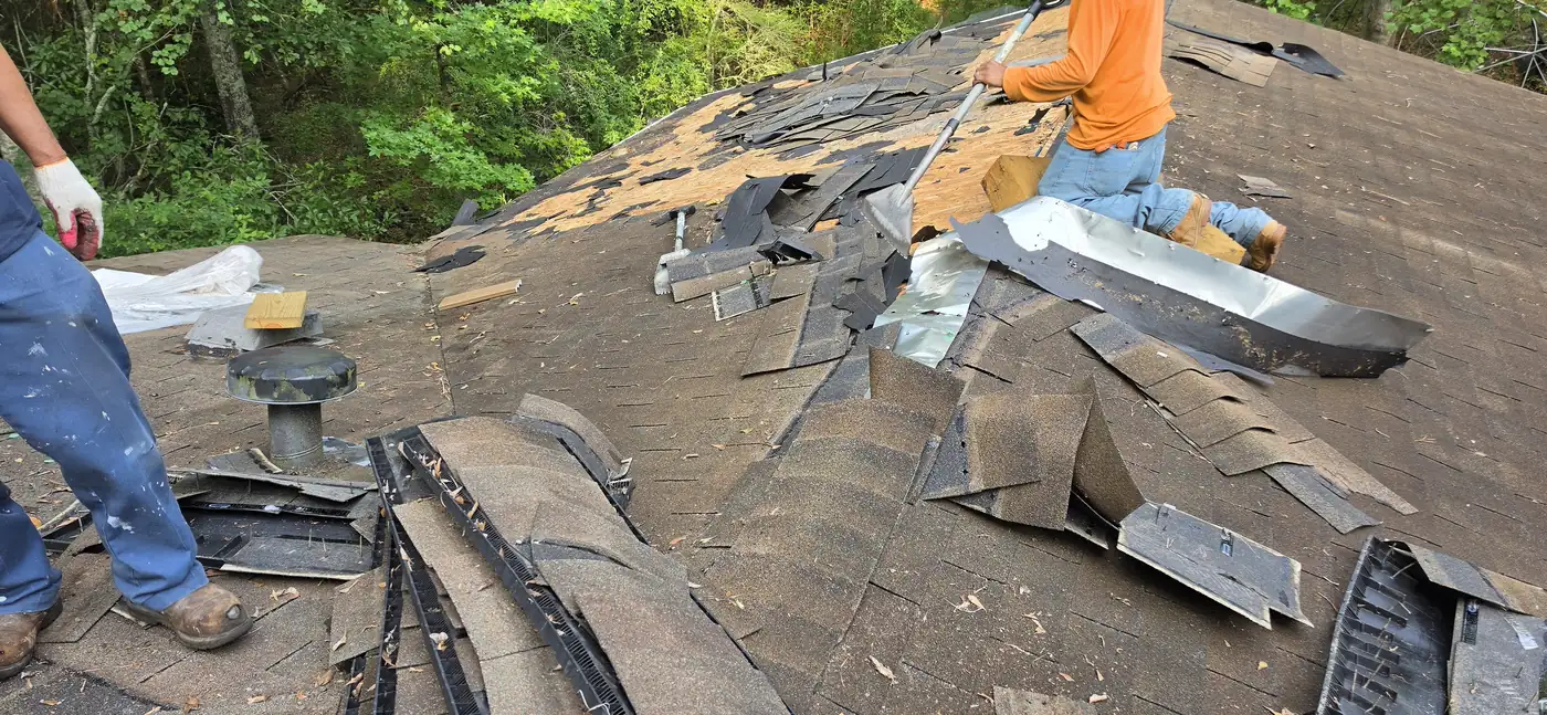 Roofing crew tearing off old shingles in Covington, GA